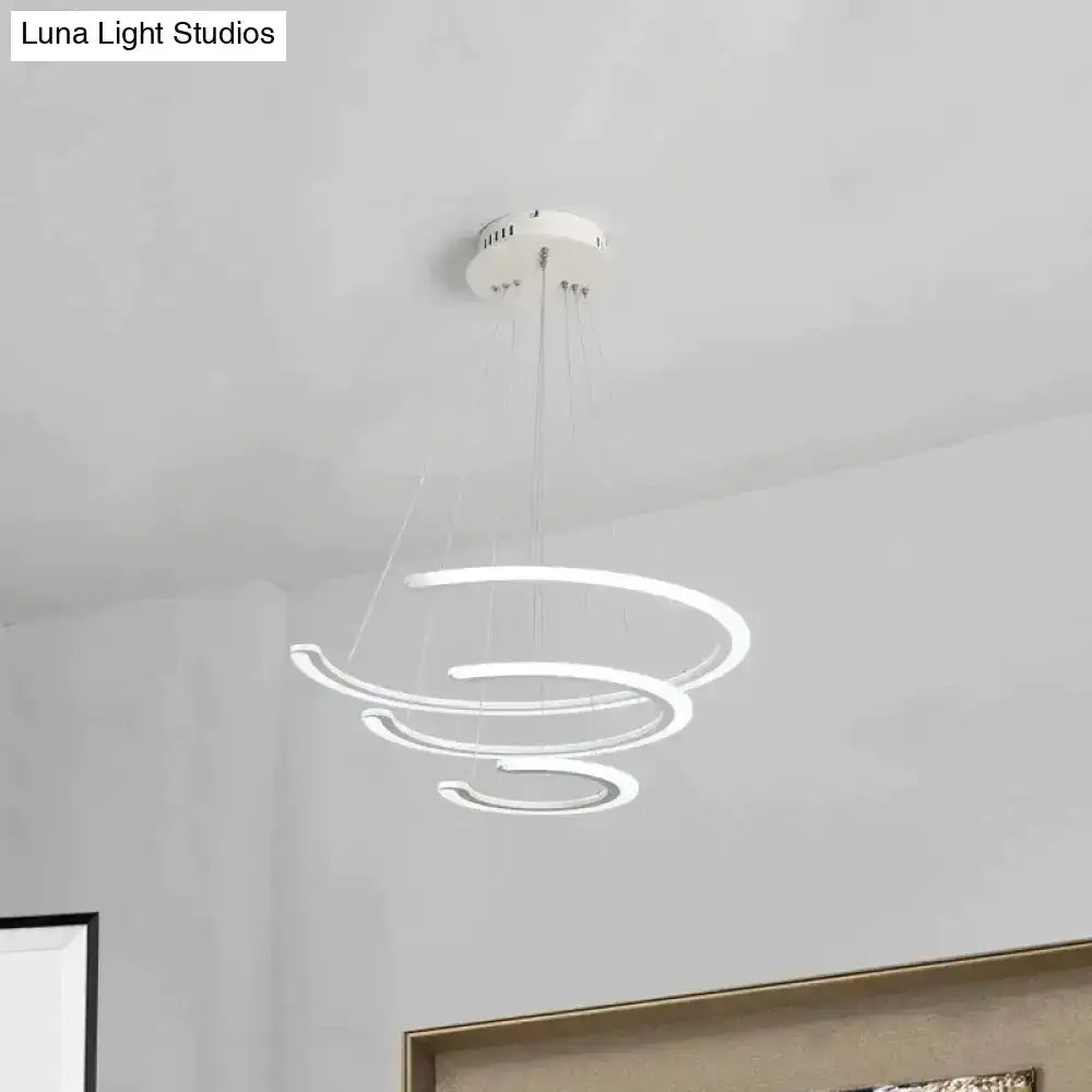 Modern white acrylic LED ring chandelier with glowing spiral rings suspended by thin cables on Tampa Home & Garden Store
