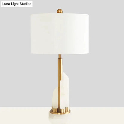 Modern white alabaster drum table lamp with brass stem and stacked alabaster accents on Tampa Home & Garden Store