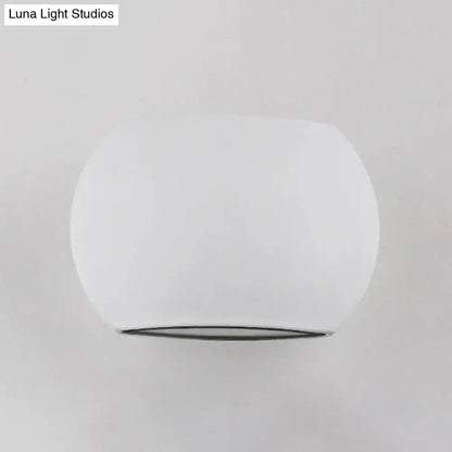 Oval LED wall lamp in white frosted finish with rounded silhouette and slim dark base Decorbites Home & Garden on Tampa Home & Garden Store