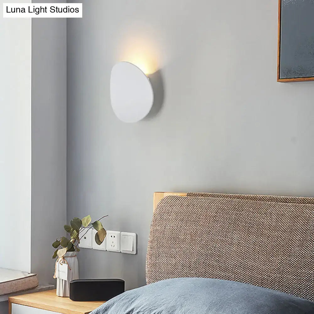 Decorbites LED wall sconce, round white disc with warm glow on gray wall on Tampa Home & Garden Store