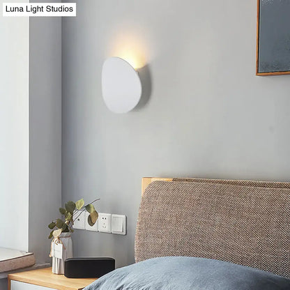 Decorbites LED wall sconce, round white disc with warm glow on gray wall on Tampa Home & Garden Store