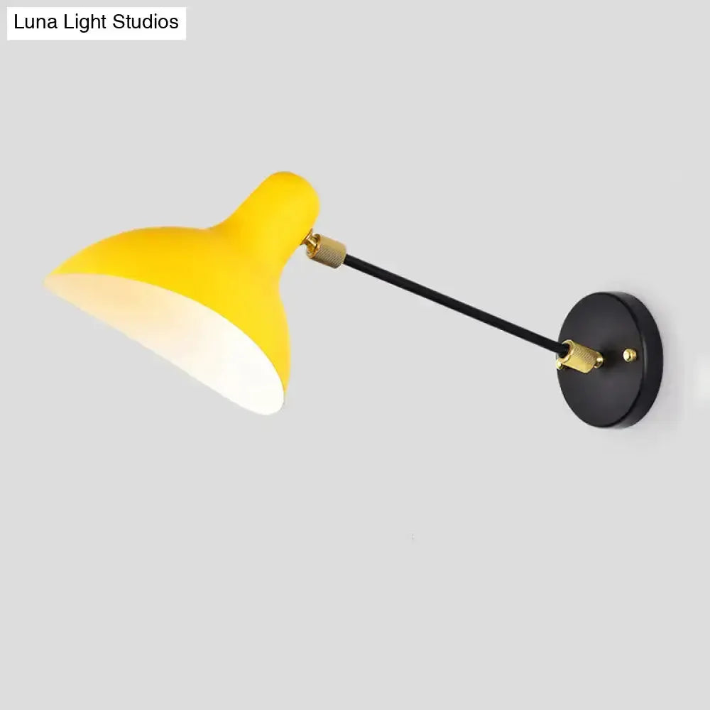 Yellow shade wall-mounted lamp with black adjustable arm and brass fittings for living area on Tampa Home & Garden Store