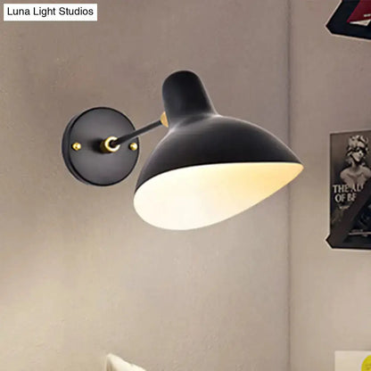Modern black wall-mounted lamp with adjustable arm, white interior shade and gold accents on Tampa Home & Garden Store