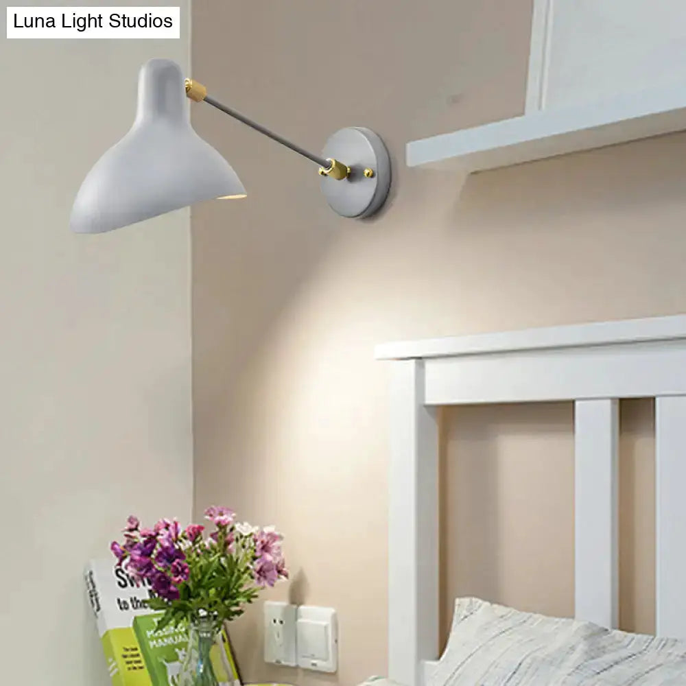 Modern white and gold wall-mounted lamp with adjustable arm above white bed headboard on Tampa Home & Garden Store