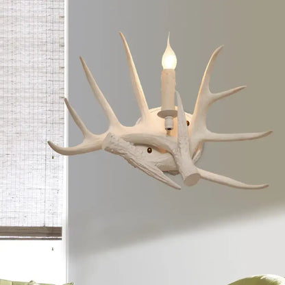White Antler Wall Sconce by Decorbites, rustic antler light with a candle-style bulb on Tampa Home & Garden Store