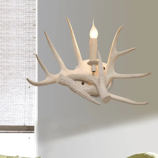 White Antler Wall Sconce by Decorbites, rustic antler light with a candle-style bulb on Tampa Home & Garden Store