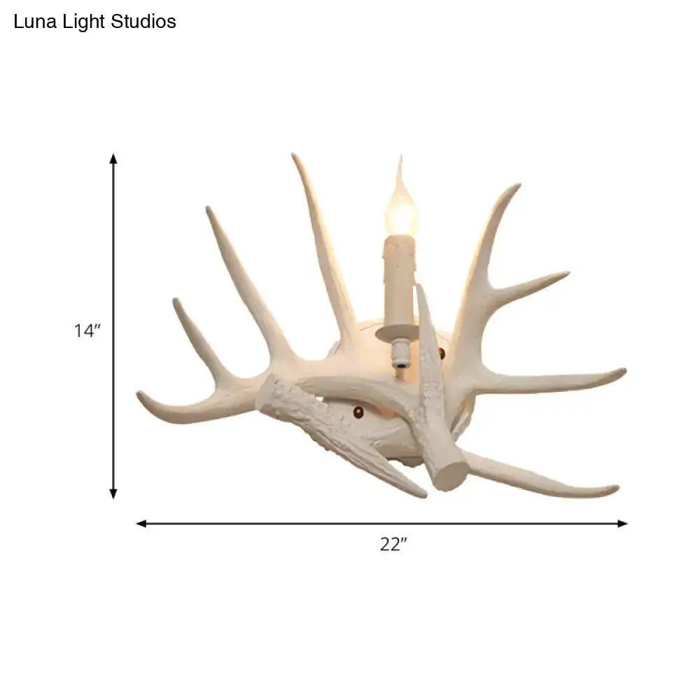 White Antler Wall Sconce with multiple ivory antlers and a candle-style bulb by Decorbites on Tampa Home & Garden Store