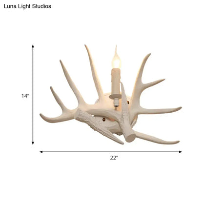 White Antler Wall Sconce with multiple ivory antlers and a candle-style bulb by Decorbites on Tampa Home & Garden Store
