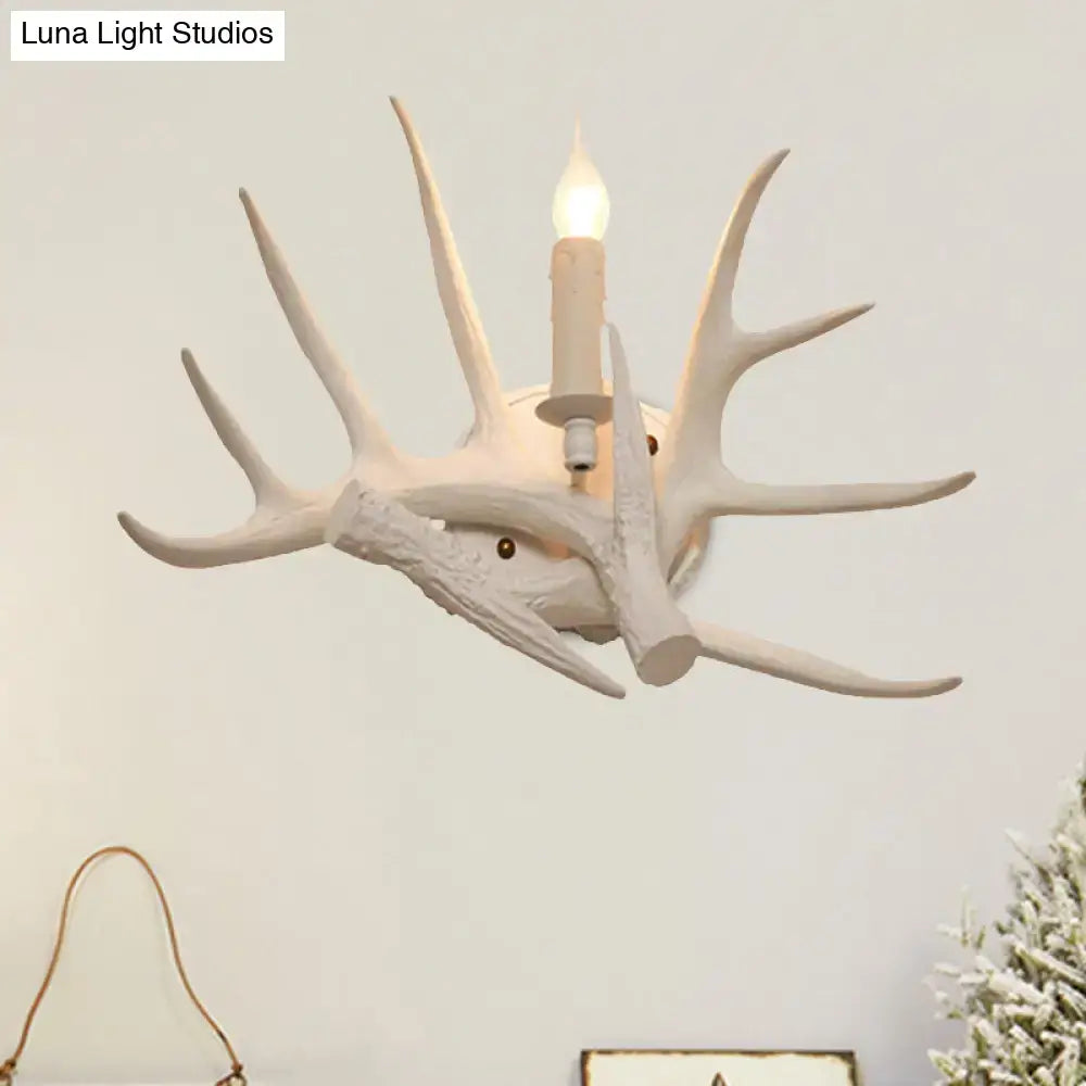 White Antler Wall Sconce by Decorbites, antler-inspired wall light with candle-style bulb on Tampa Home & Garden Store