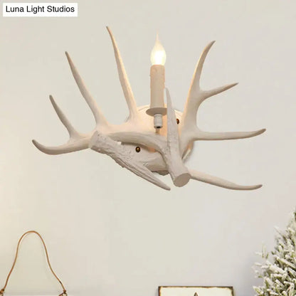 White Antler Wall Sconce by Decorbites, antler-inspired wall light with candle-style bulb on Tampa Home & Garden Store