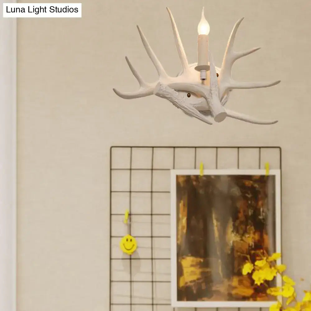 White antler wall sconce with candle bulb by Decorbites mounted on wall on Tampa Home & Garden Store