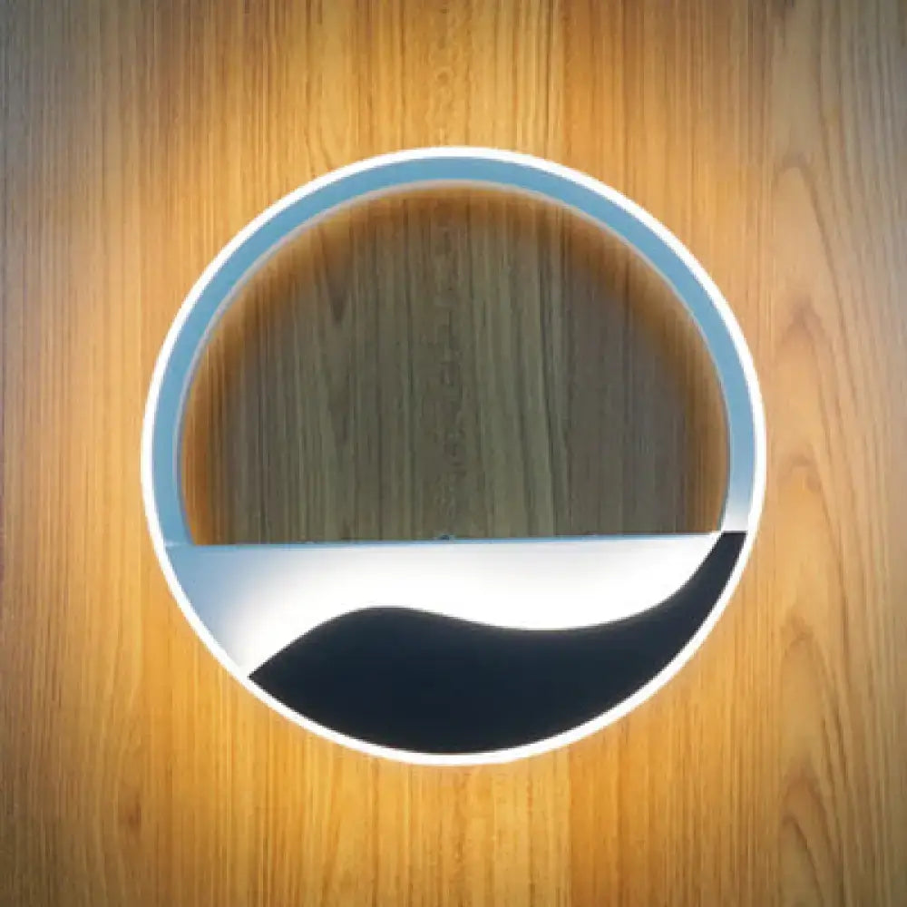 Round acrylic wall sconce with white ring, blue interior, black wave accent on wood wall on Tampa Home & Garden Store