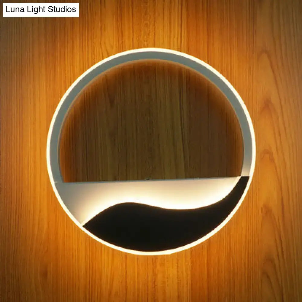 Acrylic wall sconce light with wood-textured top and black-white wave bottom, warm glow on wall on Tampa Home & Garden Store