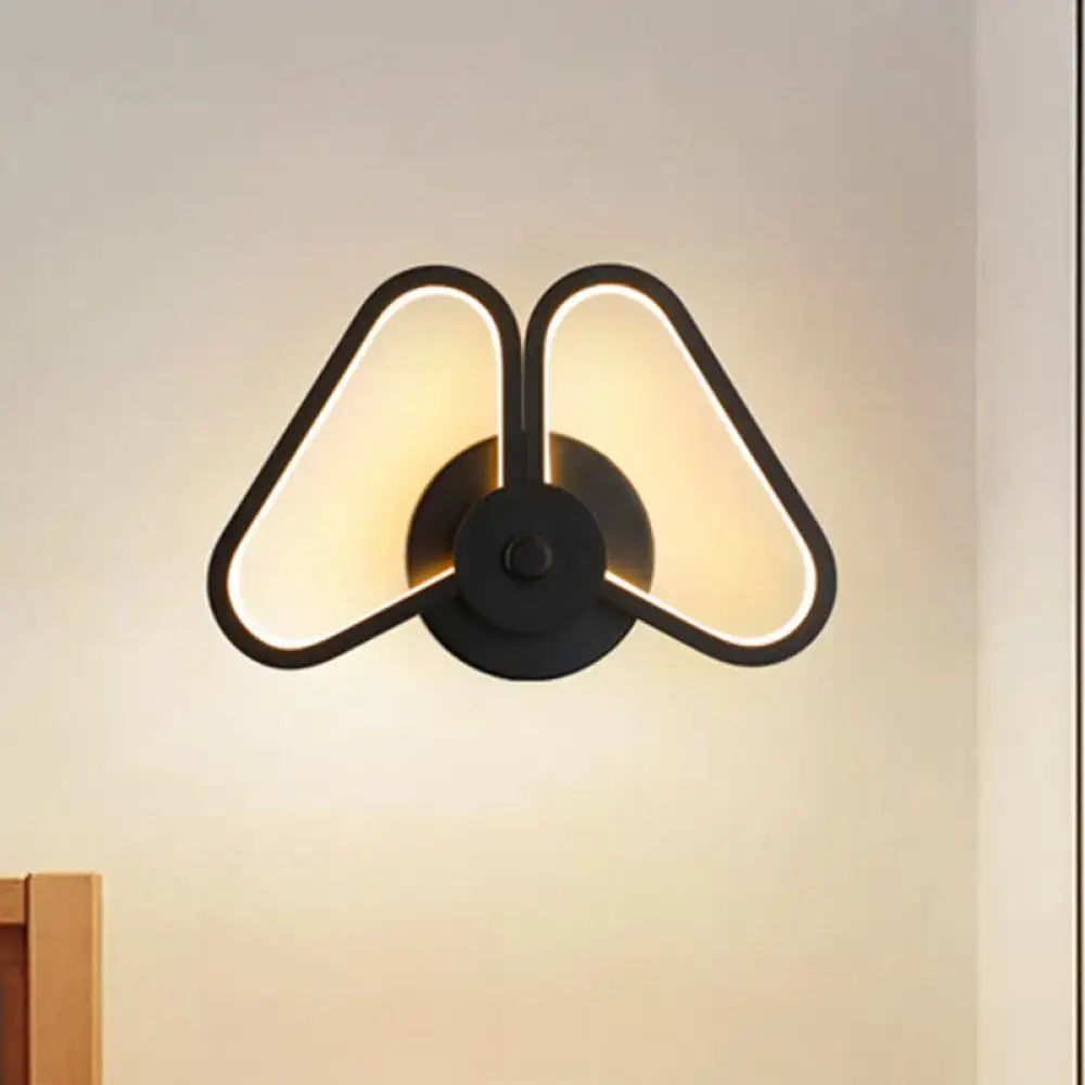 Black triangle wall sconce by Decorbites with double-triangle outline and warm LED glow on Tampa Home & Garden Store