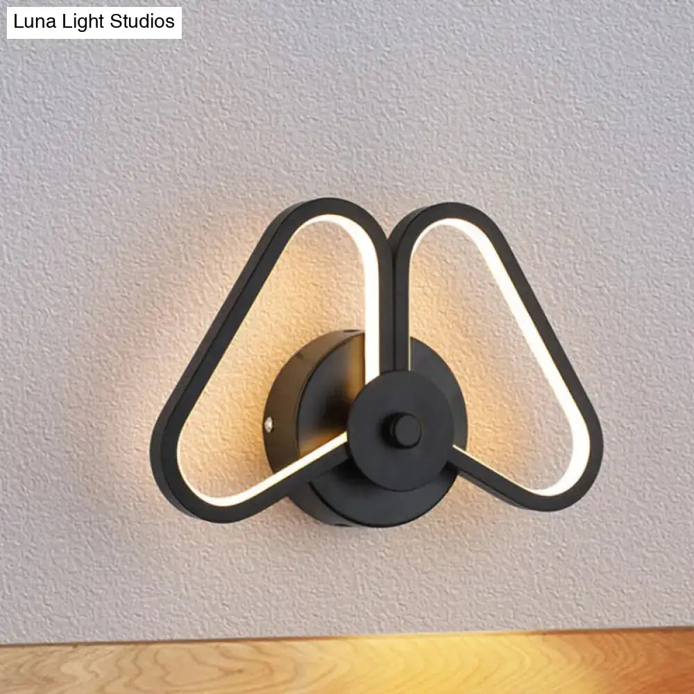 Decorbites black triangle LED wall sconce with illuminated triangular frame and round backplate on Tampa Home & Garden Store