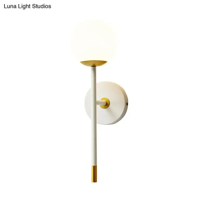 Decorbites brass frosted long-arm wall sconce with white globe shade and gold accents on Tampa Home & Garden Store