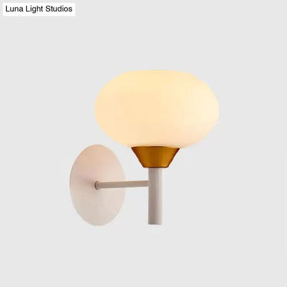 Brass opal glass minimalist wall sconce with frosted shade and circular backplate on Tampa Home & Garden Store
