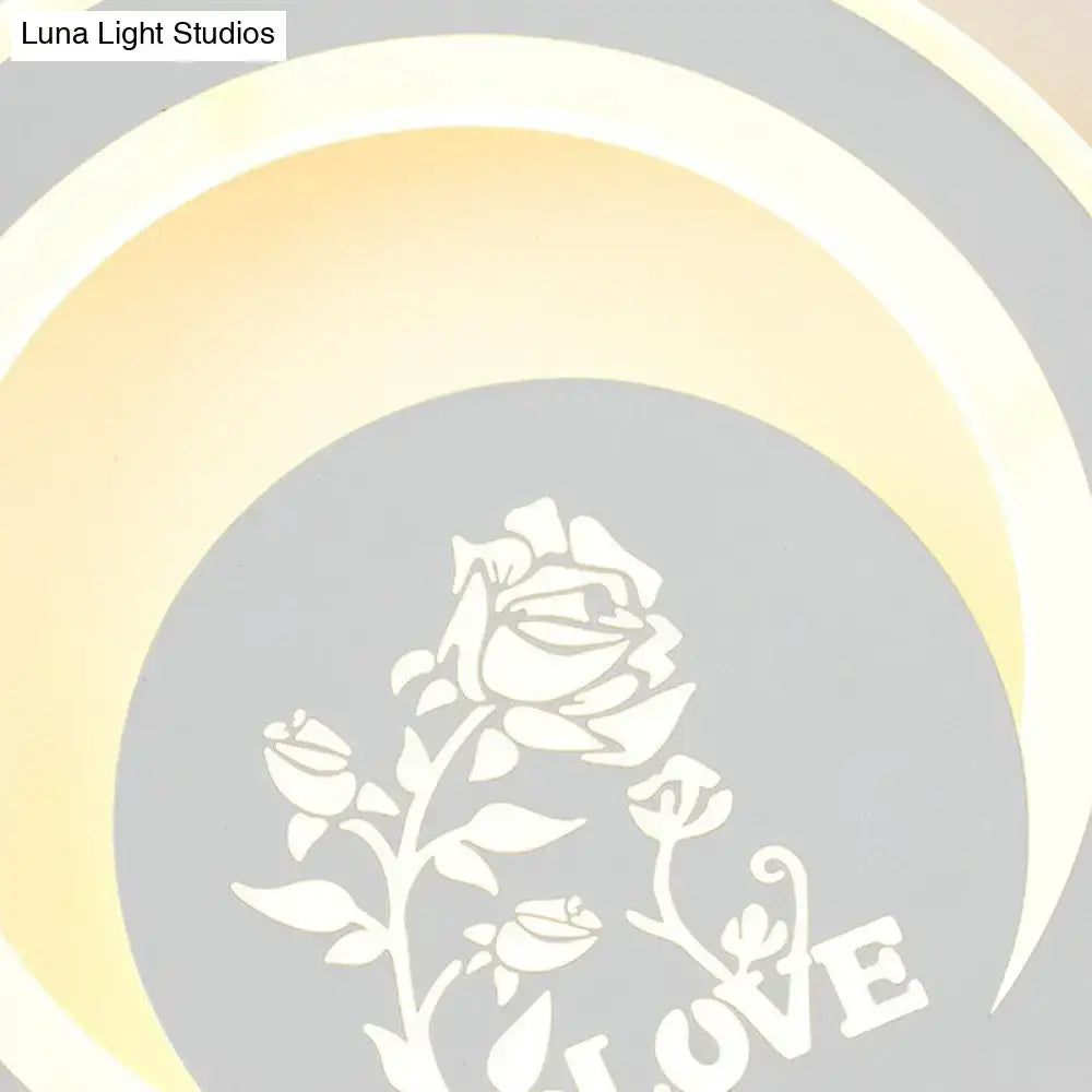 LED wall light with a gray circular panel featuring a white rose motif and LOVE text, warm concentric glow rings on Tampa Home & Garden Store
