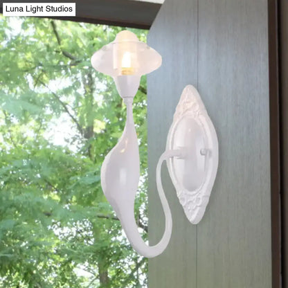 White ceramic wall sconce with curved arm and ornate backplate by Decorbites on Tampa Home & Garden Store