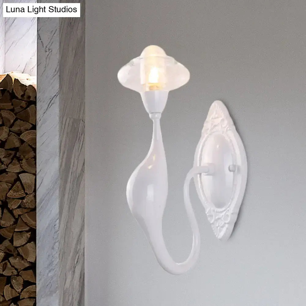 White ceramic wall sconce with curved teardrop arm and ornate backplate on gray wall on Tampa Home & Garden Store