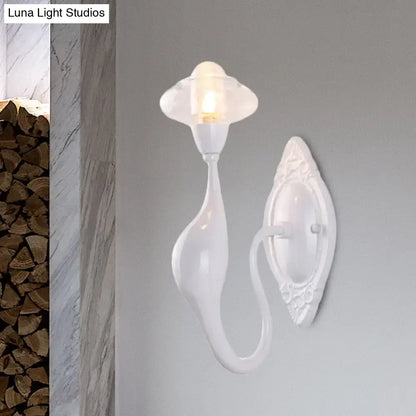 White ceramic wall sconce with curved teardrop arm and ornate backplate on gray wall on Tampa Home & Garden Store