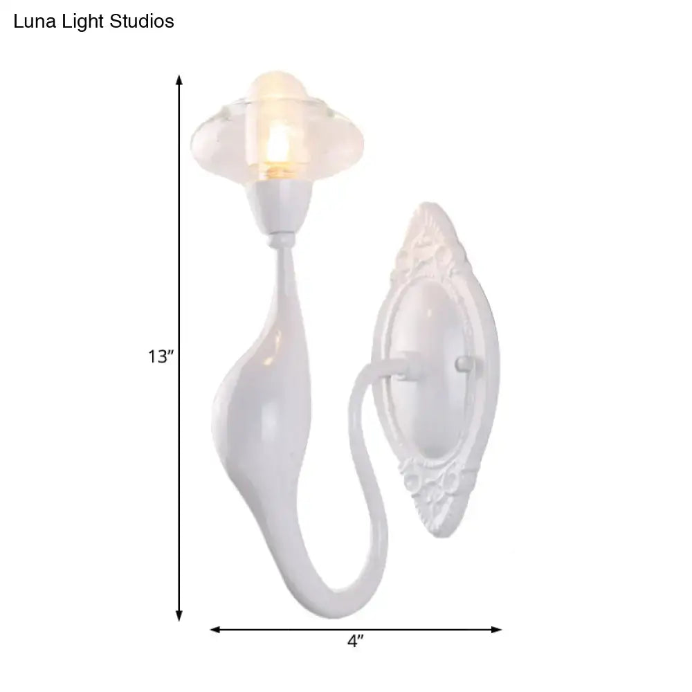 White ceramic wall sconce with ornate backplate, curved scroll arm, glass shade Decorbites on Tampa Home & Garden Store