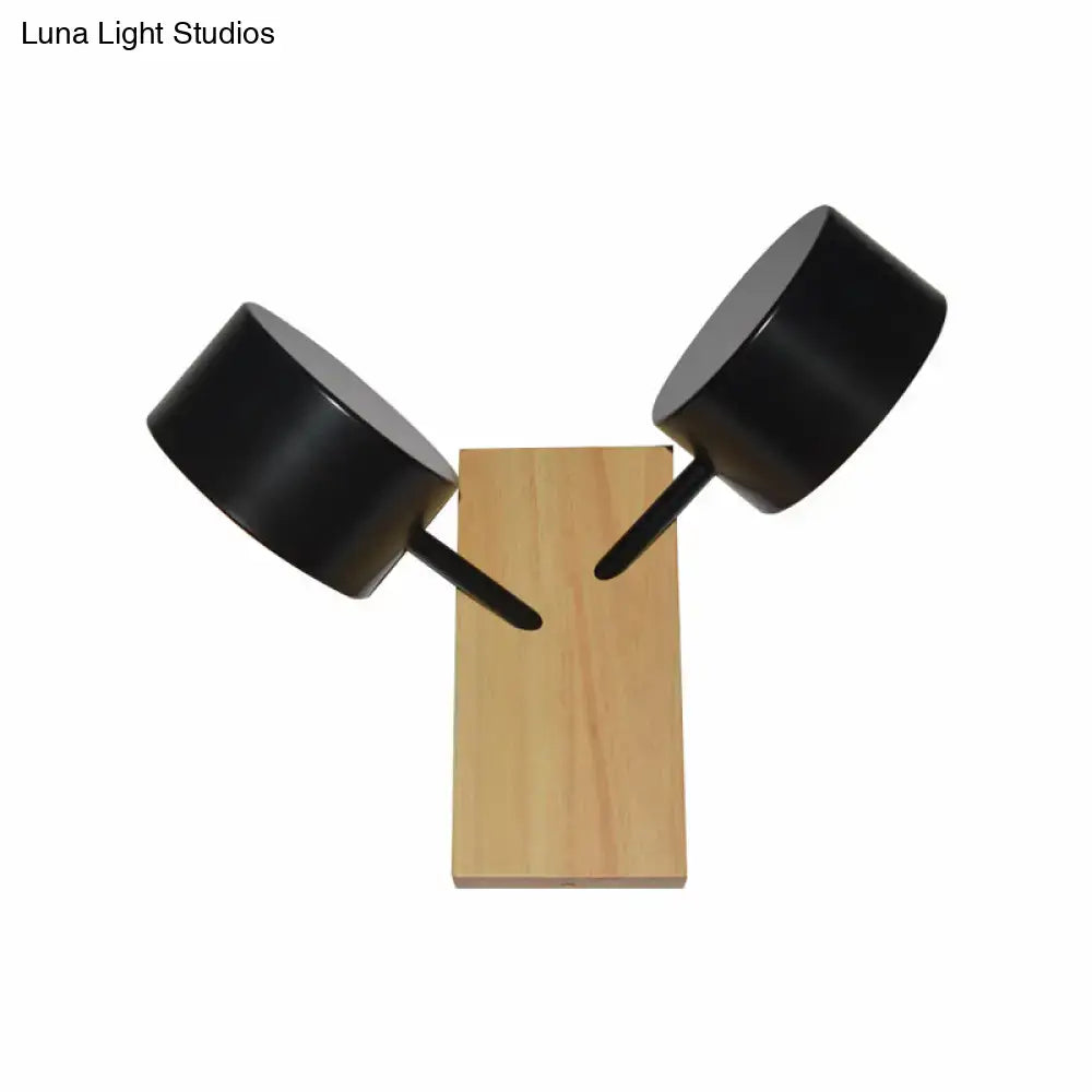 White Ceramic Drum Sconce with dual black drum shades on a wooden pedestal by Decorbites on Tampa Home & Garden Store