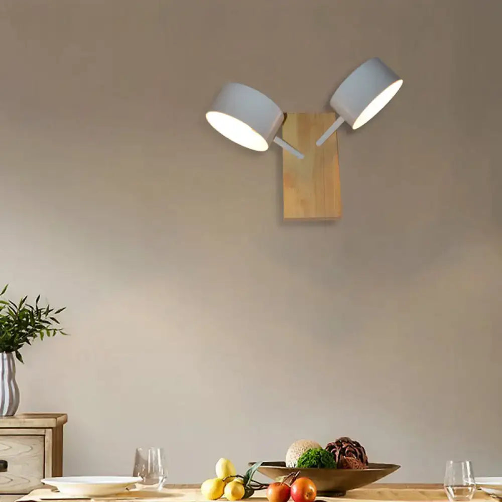 White ceramic drum wall sconce with twin shades on a wooden backplate, living room lighting on Tampa Home & Garden Store