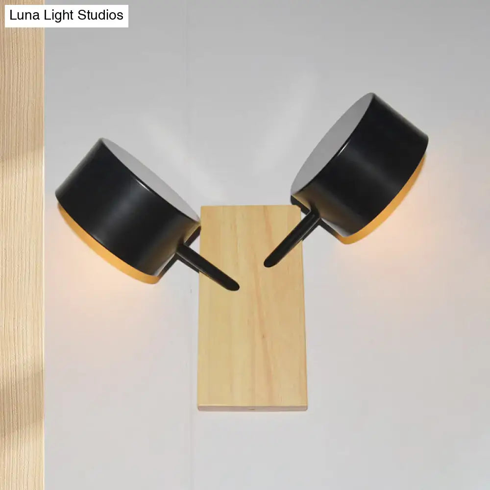 White ceramic drum sconce with natural wood backplate and dual black arms wall light on Tampa Home & Garden Store