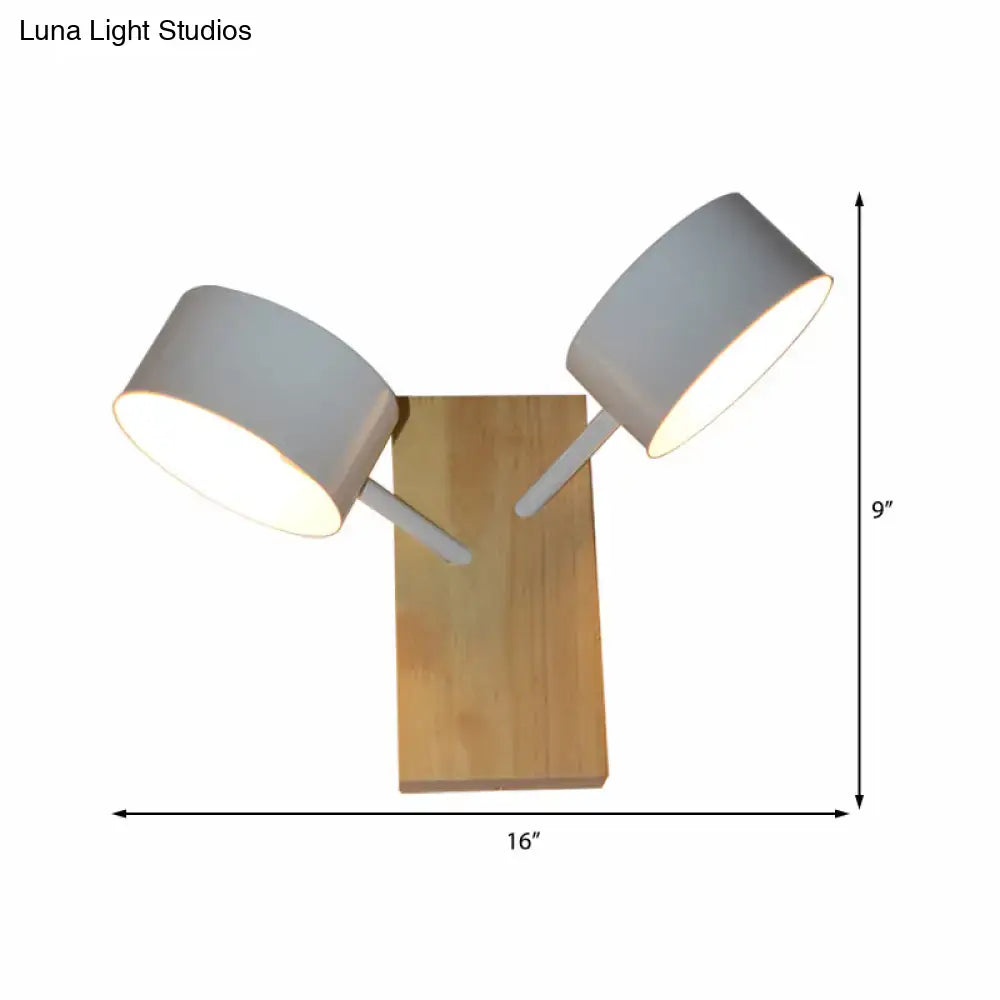 White ceramic drum sconce with two angled arms and white shades on natural wood base on Tampa Home & Garden Store