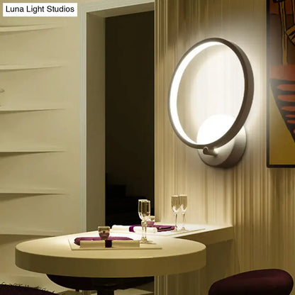 White circle LED sconce wall light by Decorbites in a modern dining area on Tampa Home & Garden Store