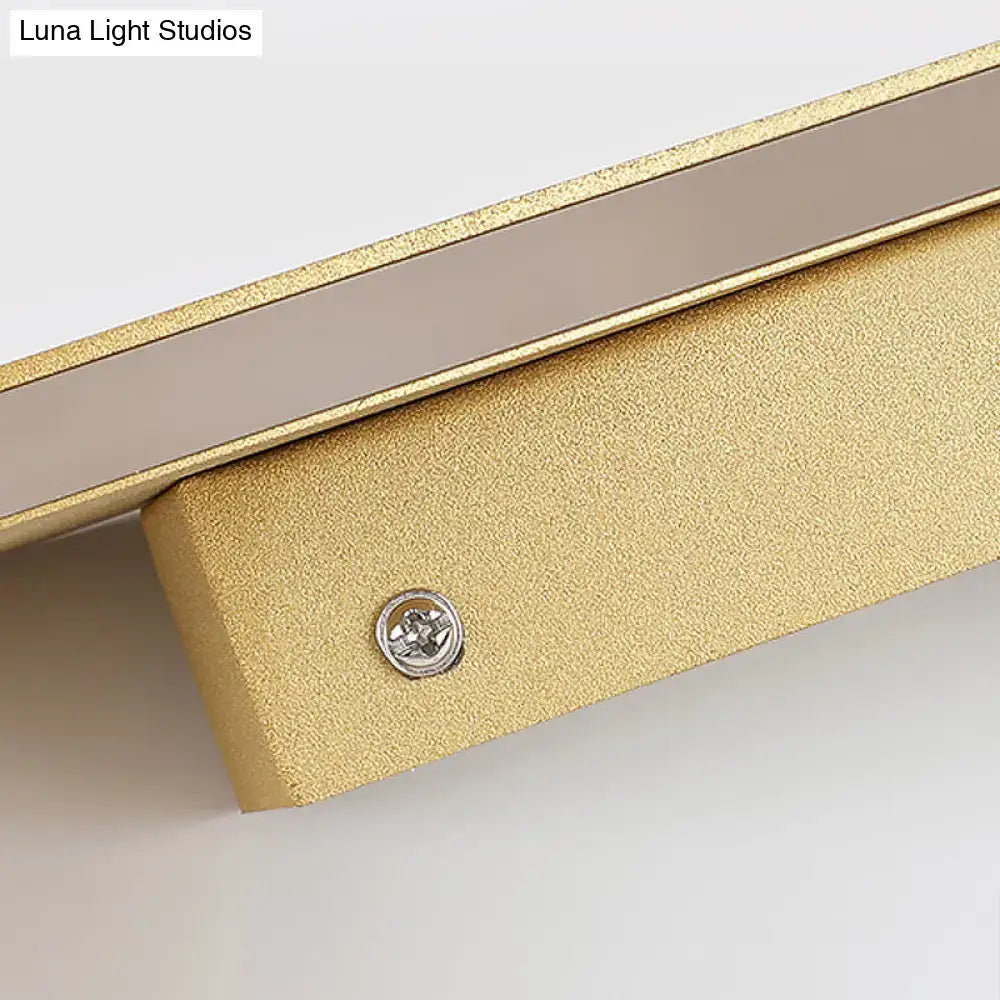 White cuboid acrylic wall sconce with warm LED mounted on a gold textured bracket on Tampa Home & Garden Store