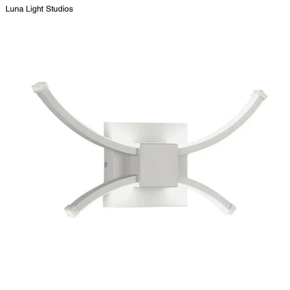 Decorbites white metal LED wall sconce with four curved arms around a square base on Tampa Home & Garden Store