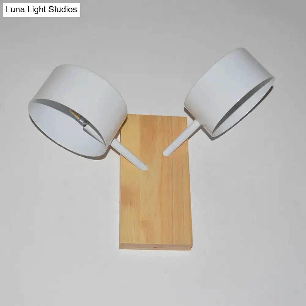 White dual-drum wood wall sconce with natural wood backplate and white shade on angled arms on Tampa Home & Garden Store