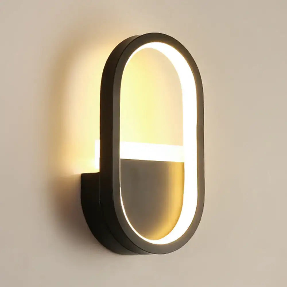 White elliptical LED wall sconce with black frame by Decorbites on Tampa Home & Garden Store