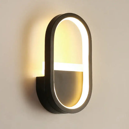 White Elliptical LED Wall Sconce with dark frame and illuminated inner ring on Tampa Home & Garden Store