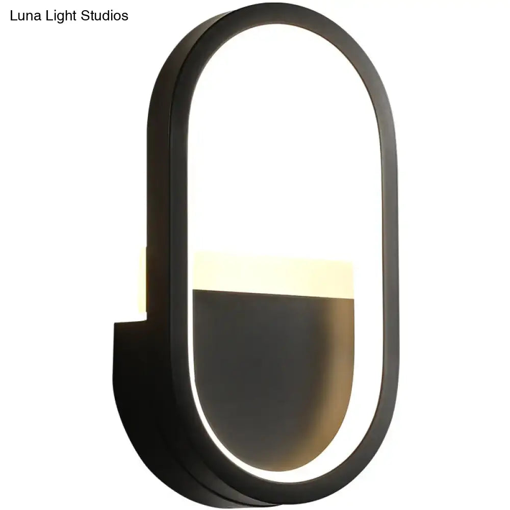 White elliptical LED wall sconce with black frame by Decorbites, glowing inner edge on Tampa Home & Garden Store