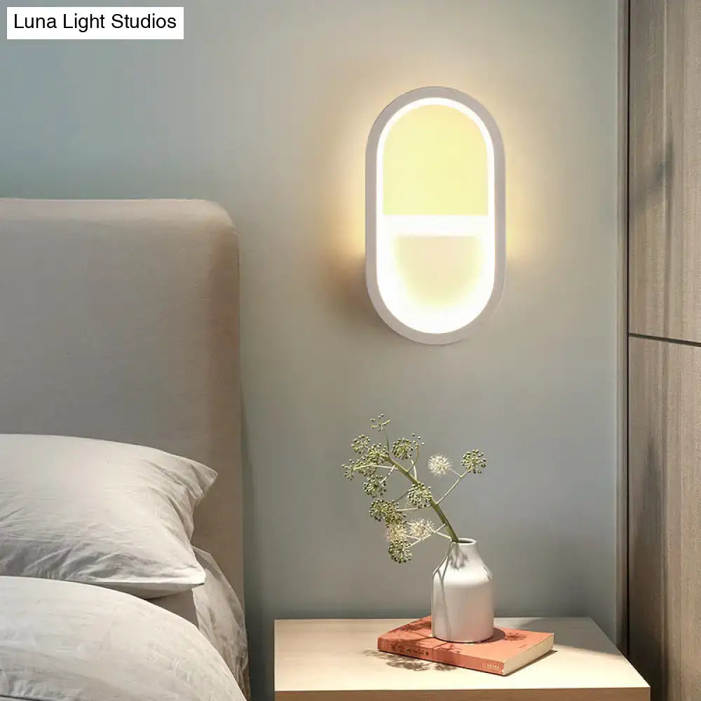 Decorbites White Elliptical LED Wall Sconce mounted on bedroom wall beside nightstand on Tampa Home & Garden Store