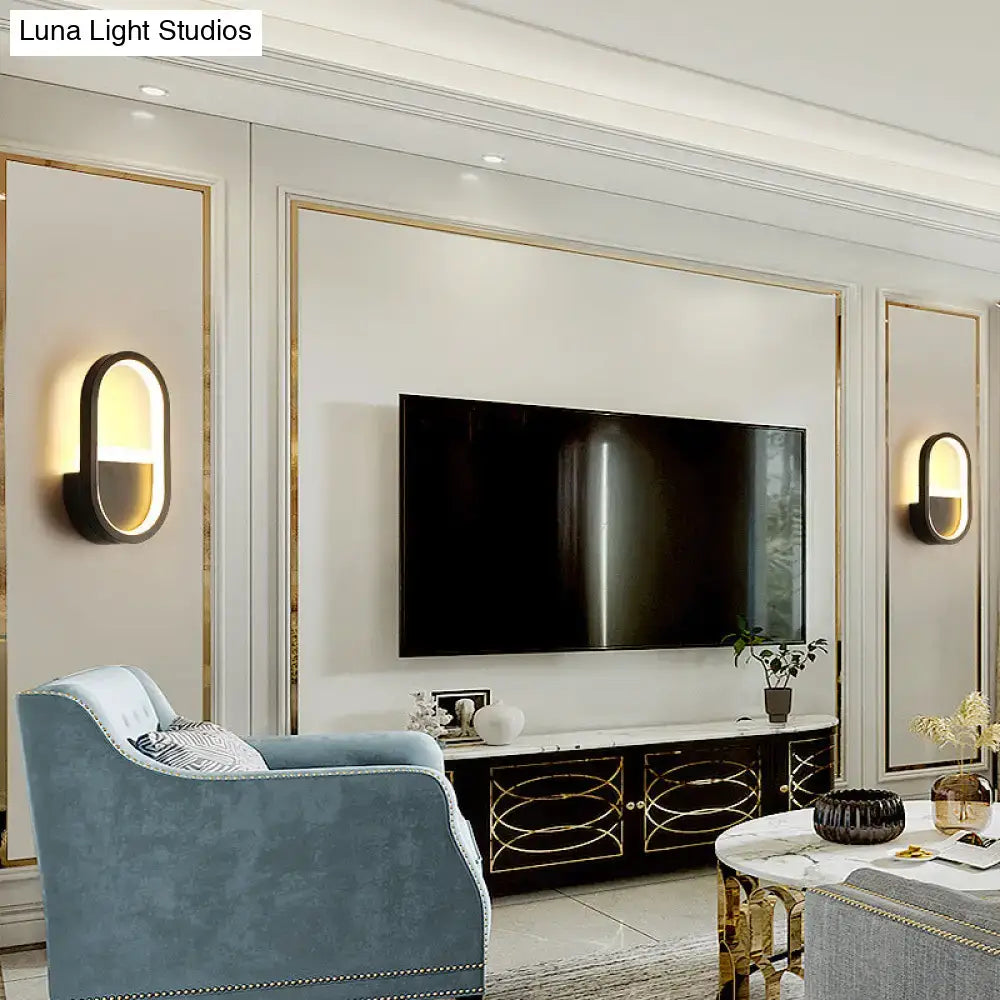 White Elliptical LED Wall Sconce pair by Decorbites, modern oval wall lights flanking a TV on Tampa Home & Garden Store