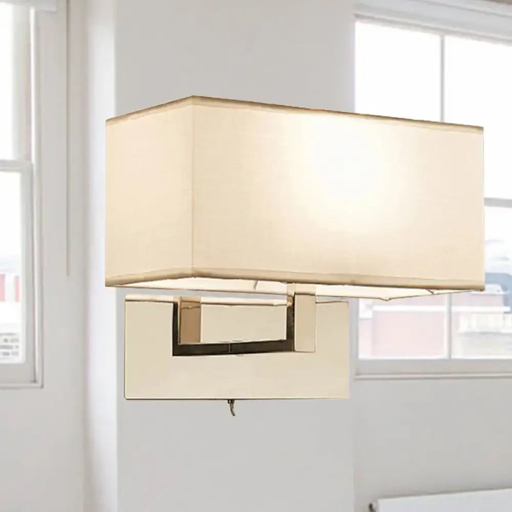 White brass wall sconce with rectangular cream fabric shade and brass base on Tampa Home & Garden Store