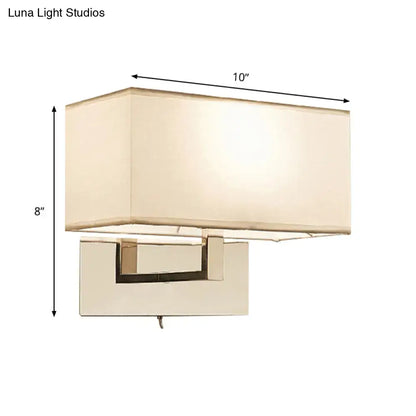 White brass wall sconce with cream fabric shade and rectangular backplate by Decorbites on Tampa Home & Garden Store