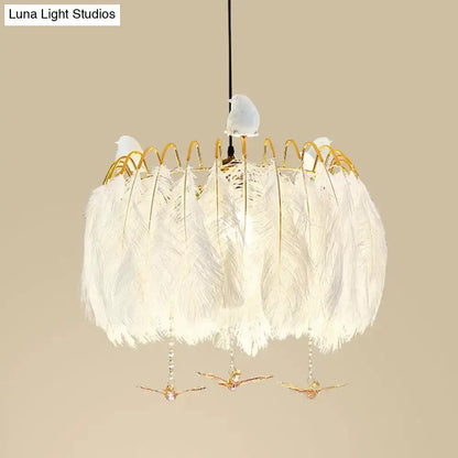 Modern white feather chandelier pendant light with gold wire frame and bird accents on Tampa Home & Garden Store