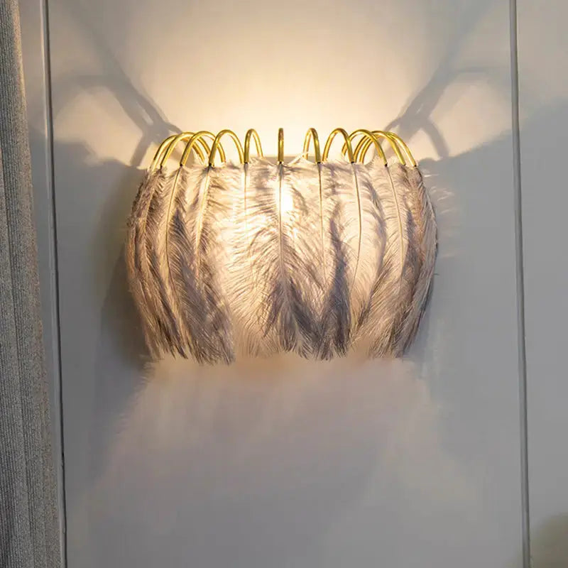 Modern white feather metal wall sconce with gold loop frame by Decorbites on Tampa Home & Garden Store