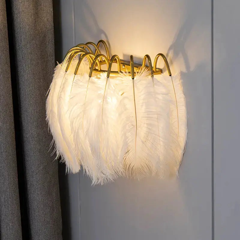 Modern white feather metal wall sconce with gold arched frame and fluffy shade on Tampa Home & Garden Store