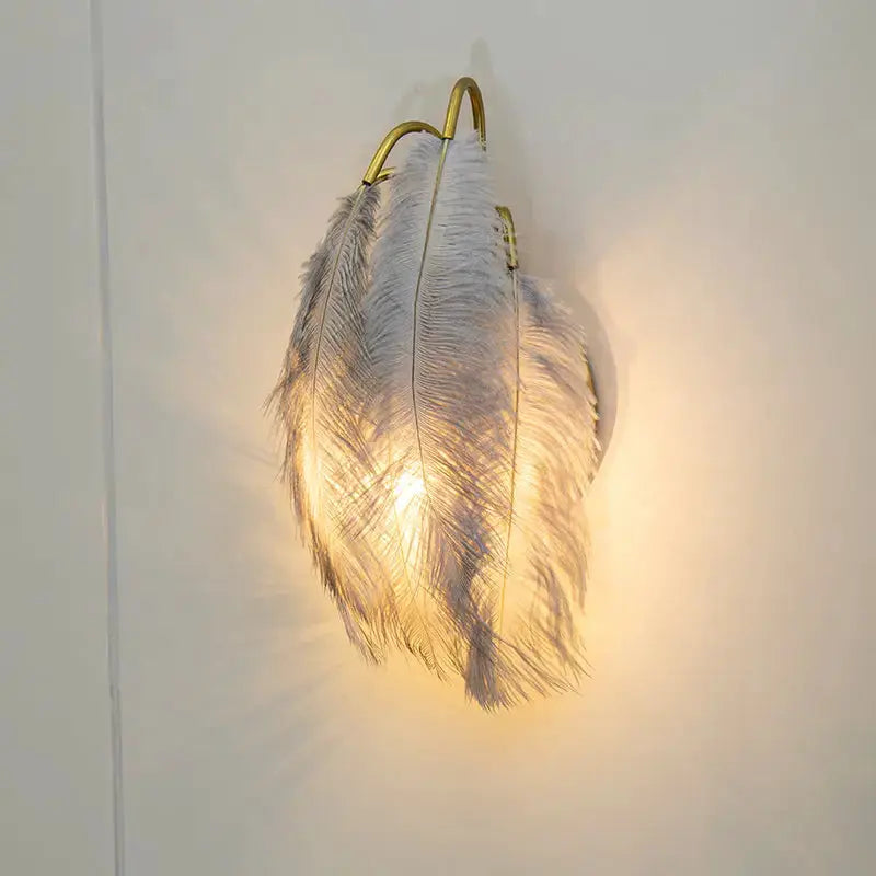 Modern white feather metal wall sconce Decorbites with gold arches warm glow on Tampa Home & Garden Store