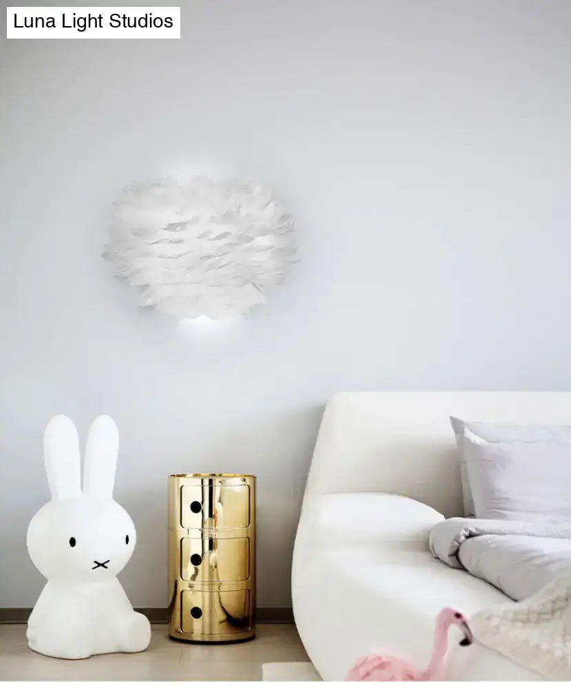 White Feather Wall Lamp by Decorbites above a white sofa with a gold side table and bunny lamp on Tampa Home & Garden Store