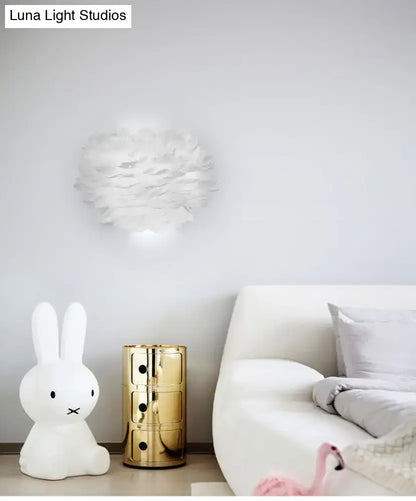 White Feather Wall Lamp by Decorbites above a white sofa with a gold side table and bunny lamp on Tampa Home & Garden Store