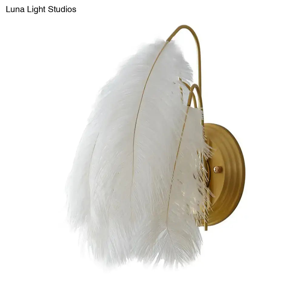 White feather bedroom sconce by Decorbites with brass backplate and feather shade on Tampa Home & Garden Store