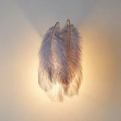 White Feather Bedroom Sconce by Decorbites with gold arches and fluffy white feathers, warm glow on Tampa Home & Garden Store