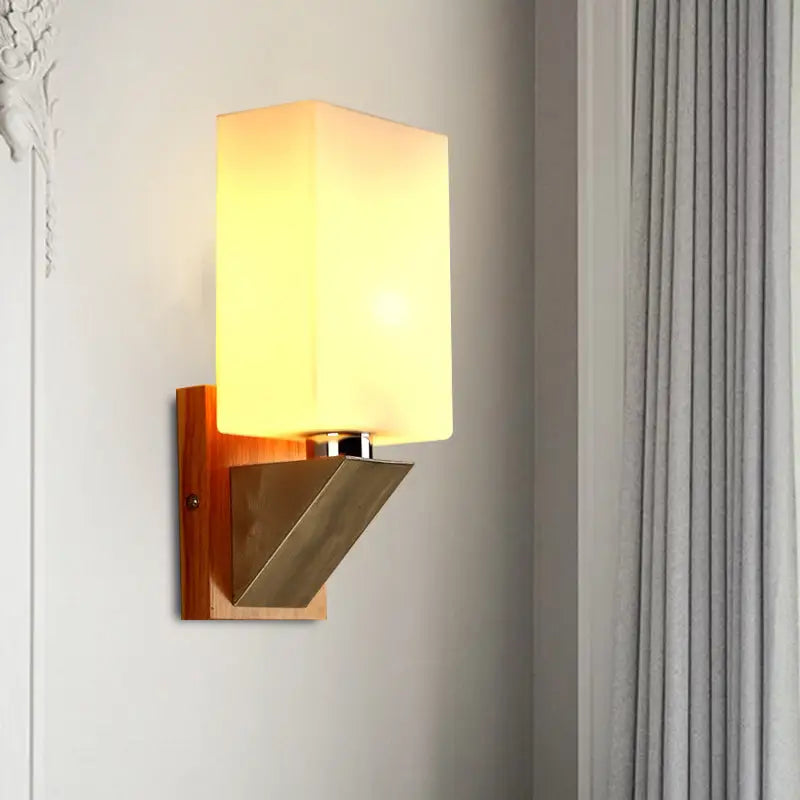 White glass wall lamp with warm glow, wooden backplate and metal angular mount on Tampa Home & Garden Store